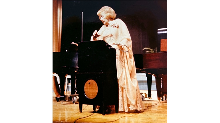 Lady playing theremin instrument